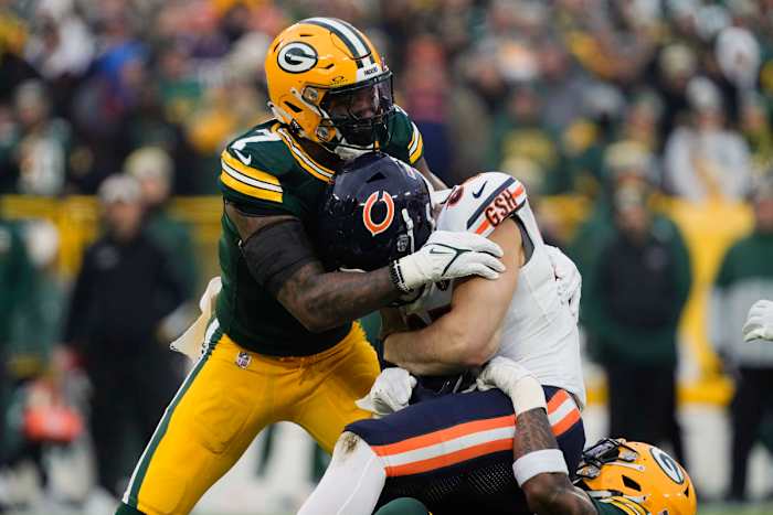 Jan 7, 2024; Green Bay, Wisconsin, USA; Green Bay Packers linebacker Quay Walker (7) tackles Chicago Bears quarterback Justin Fields (1) during the first quarter at Lambeau Field. © Jeff Hanisch-USA TODAY Sports